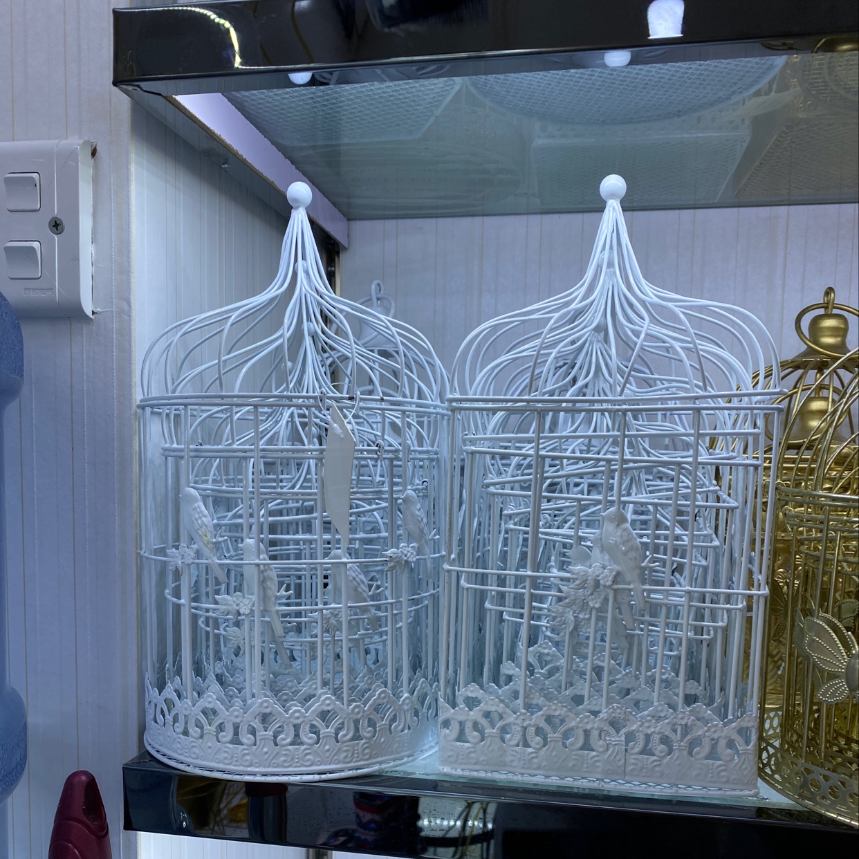 A 6-square-shaped pointed-top bird tin cage in white