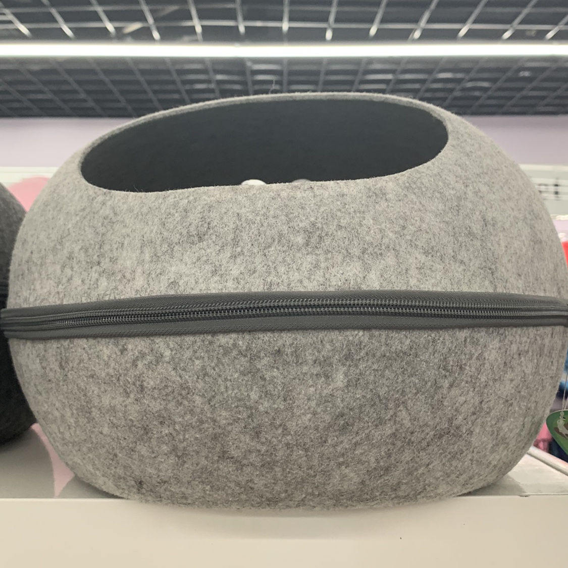 A grey circular pet bed