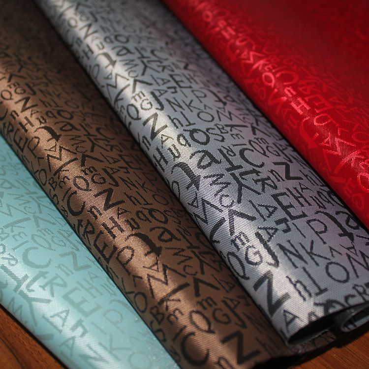 2020 tela de tela de poliéster tela de equipaje tela de impresión jacquard tela de PVC engrosada pequeña letra impresa Specification image