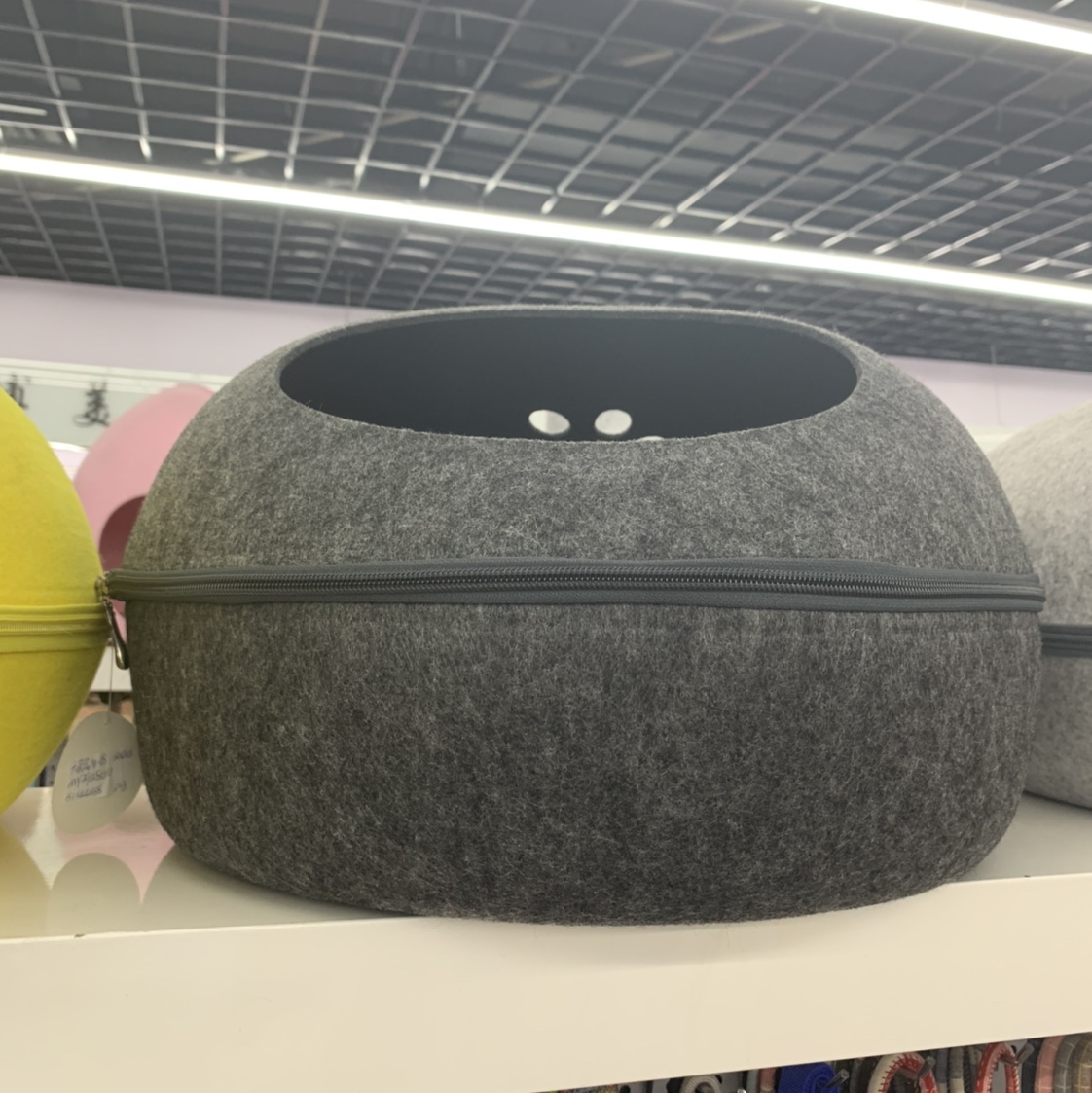 A black and grey circular pet bed