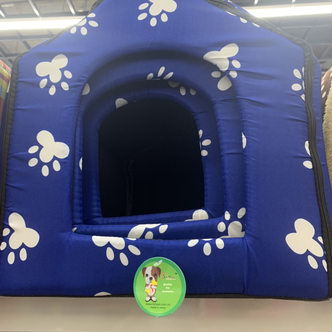 A pet bed set with a blue background and white footprints
