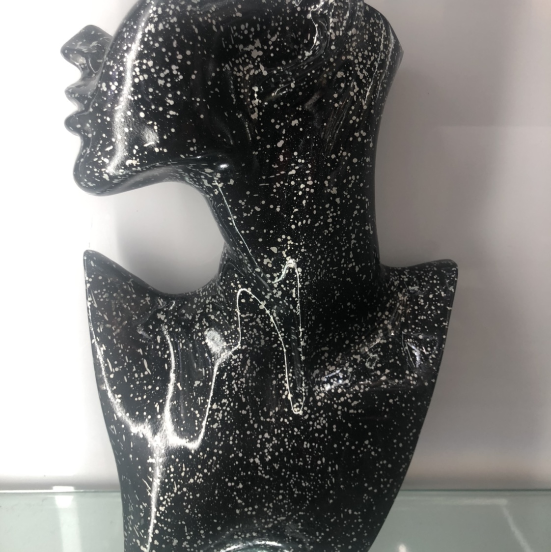 The resin portrait has black dots