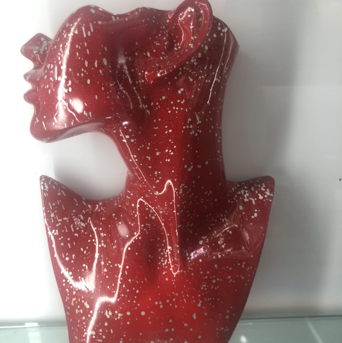 The resin avatar has a red dot