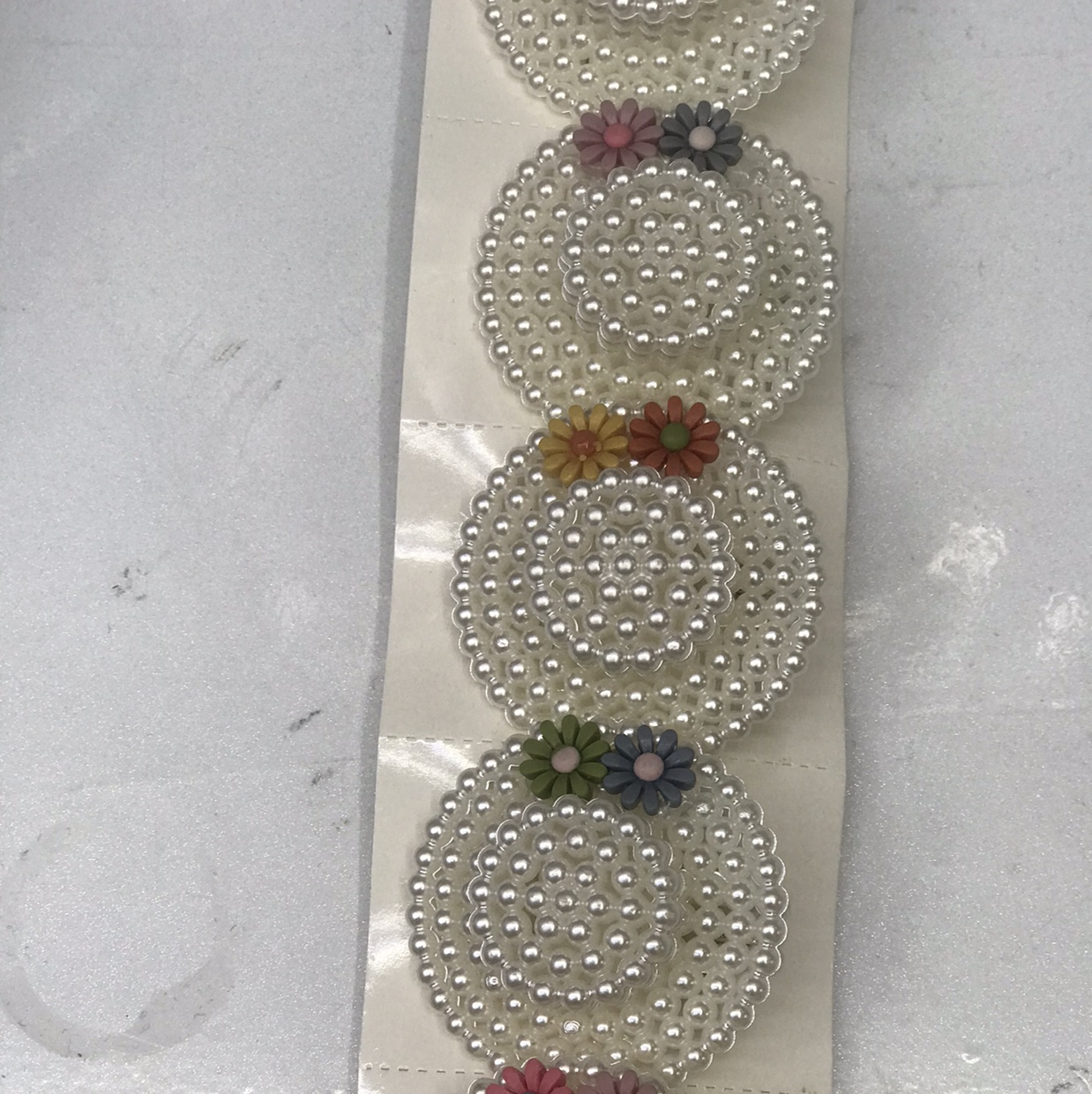 A pearl hat with colorful flowers thumbnail