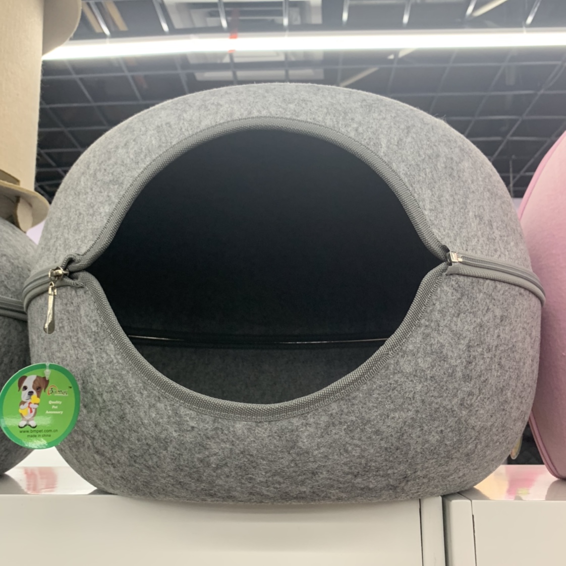 A grey circular opening pet bed