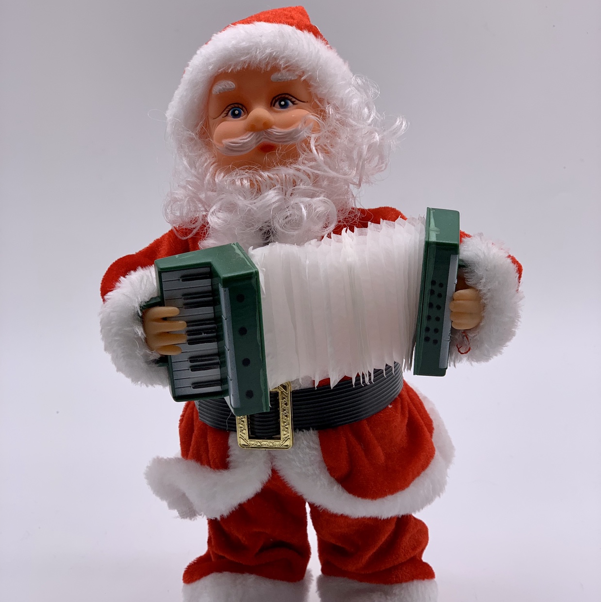 Santa Claus, 30 centimeters tall, holding an accordion