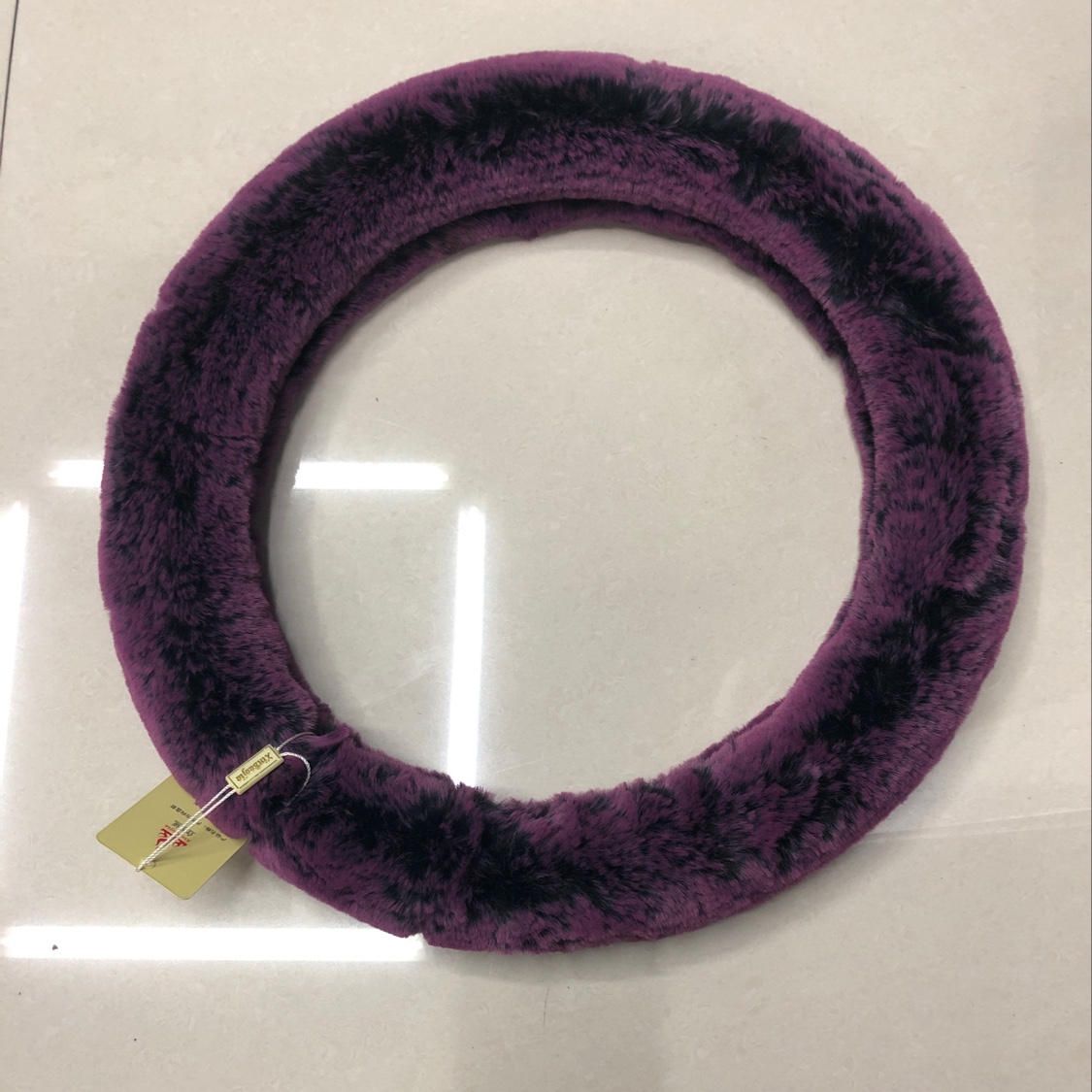 The car steering wheel cover is a plush deep purple thumbnail