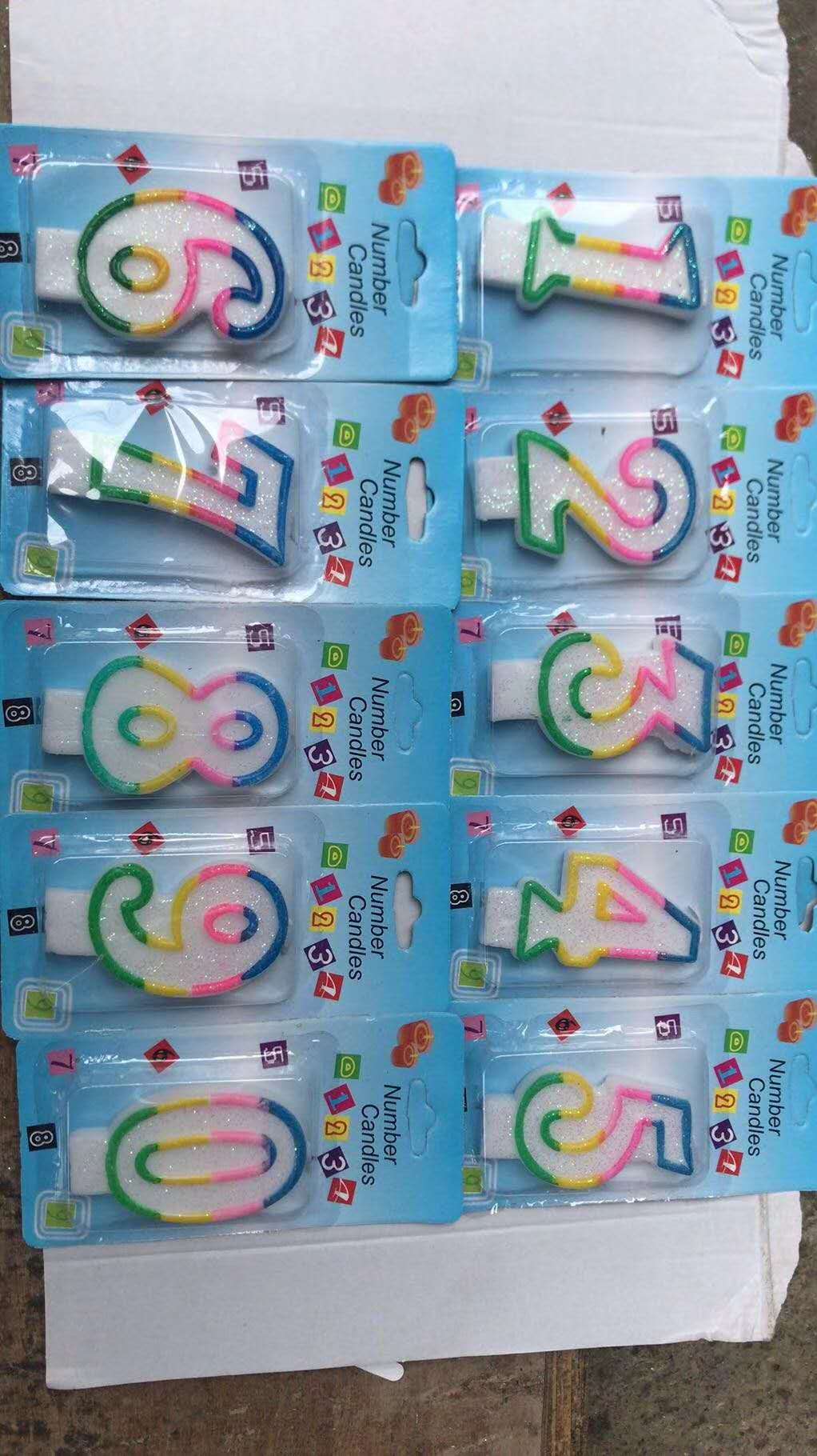 Upscale birthday cakes decorated with red, green, blue and white numbers full figure