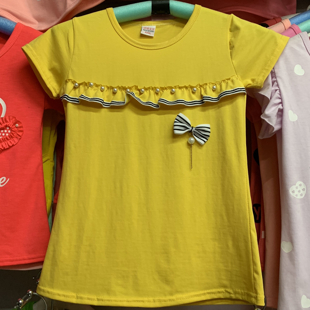 A girl with a bow in short sleeves