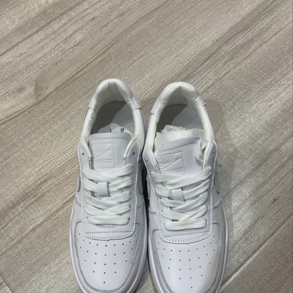 Close-up of breathable small white sneakers with detailed texture