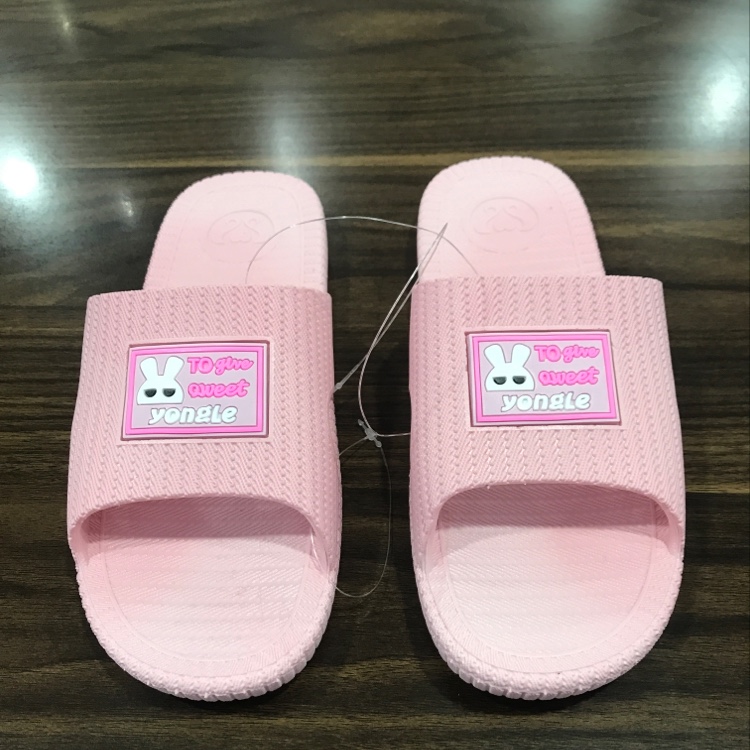 Little white rabbit in women's slippers
