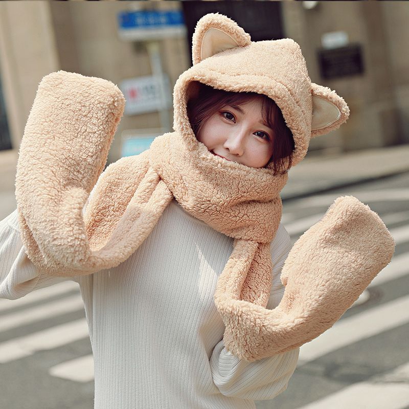 A plush hat, scarf and gloves set for a cute winter girl with thick cat ears and warm three-piece cycling neck