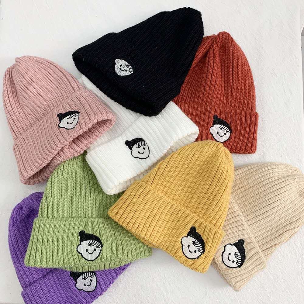 Children and little girls embroider knitted hats thumbnail
