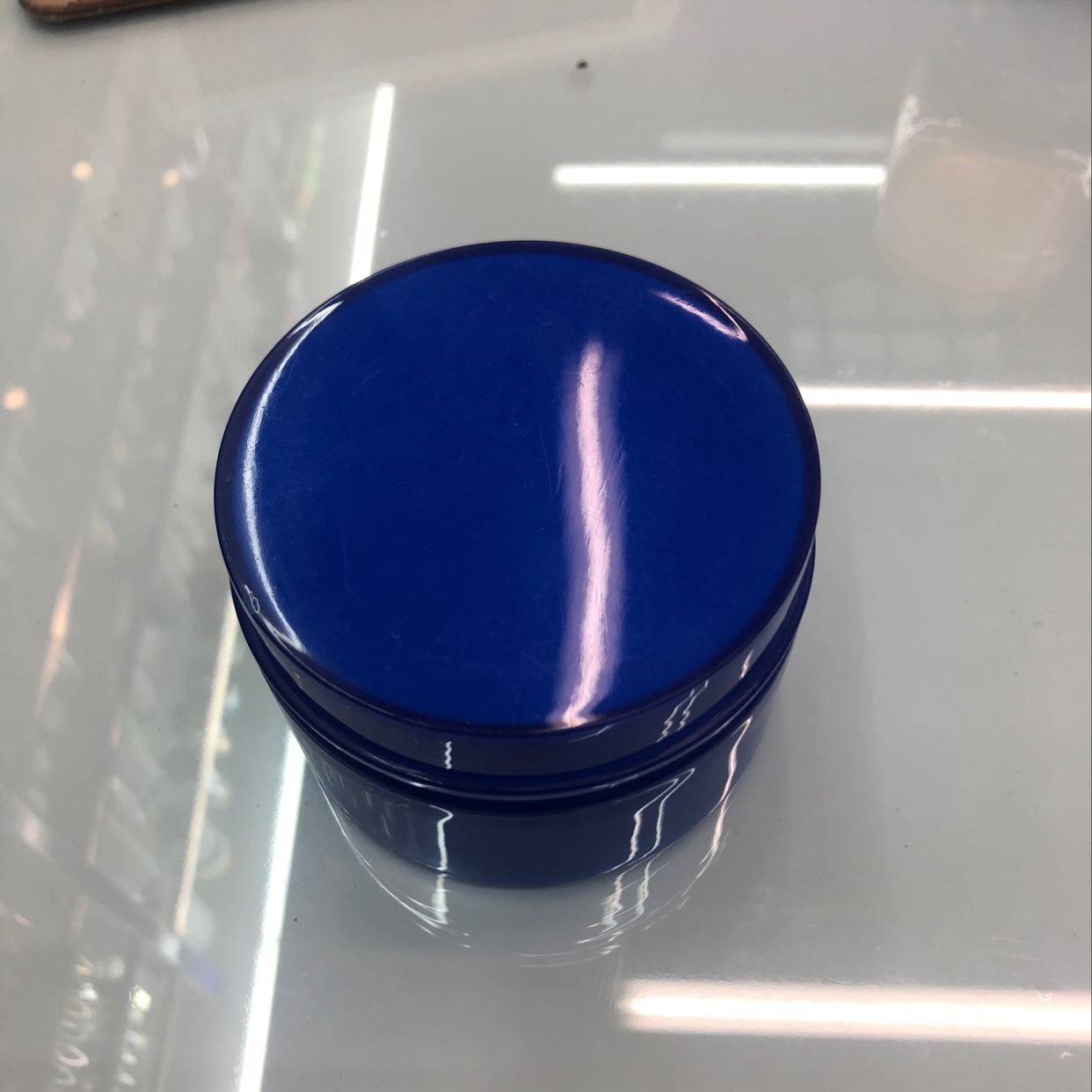 Dark blue cream bottle thumbnail
