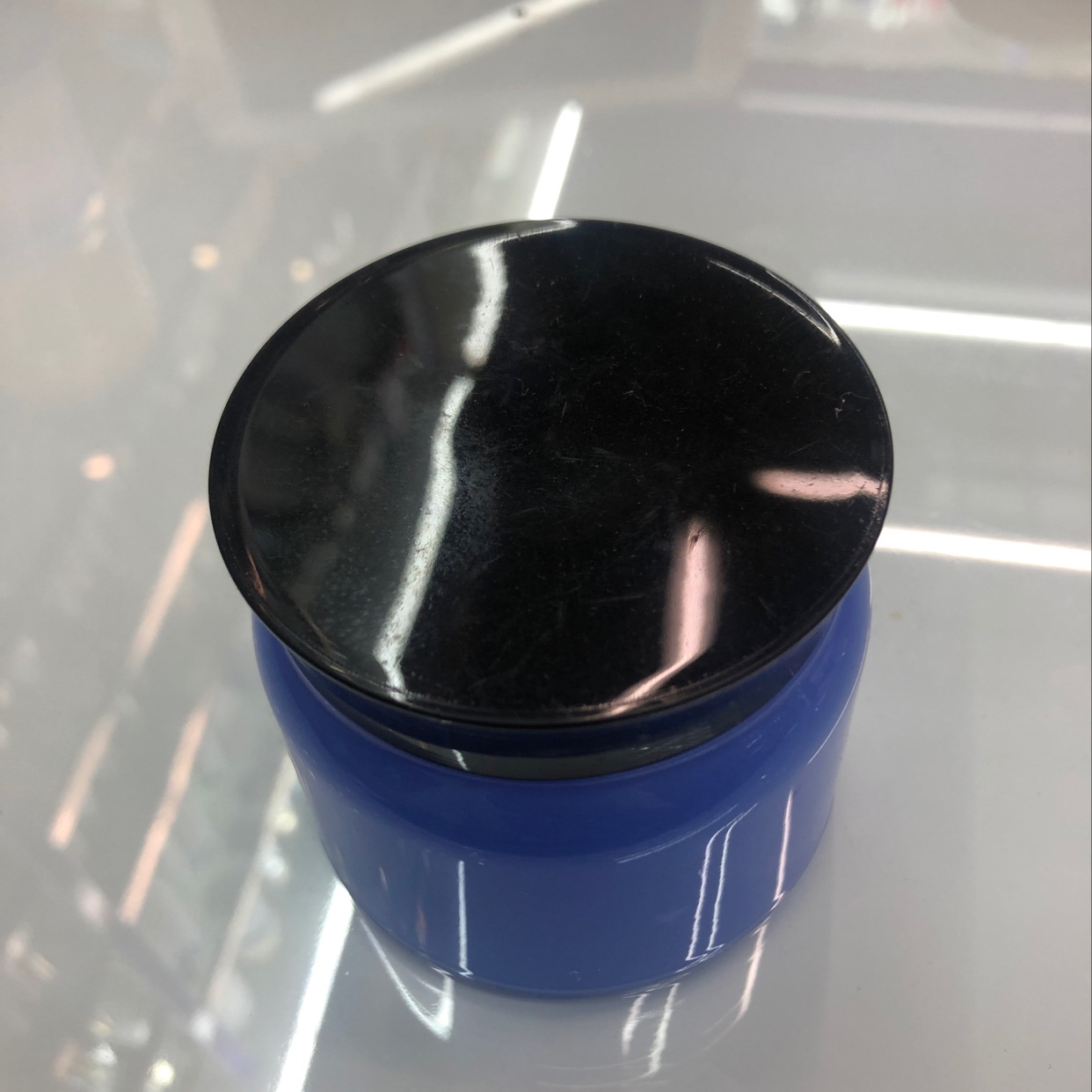 Purple bottle with black lid cream bottle