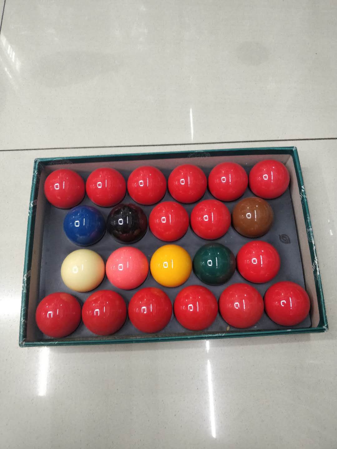 A green box of billiards or snooker