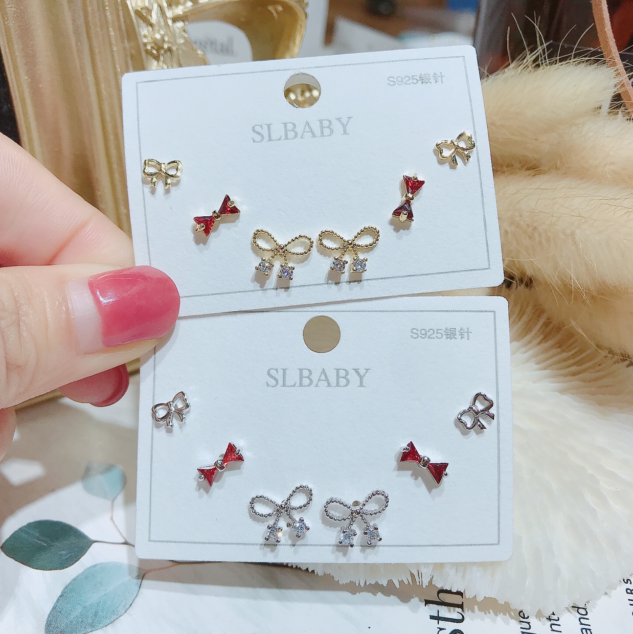 A pair of cute bow ties with many pairs of stud earrings