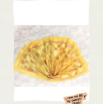 A yellow polka dot shawl is a scarf