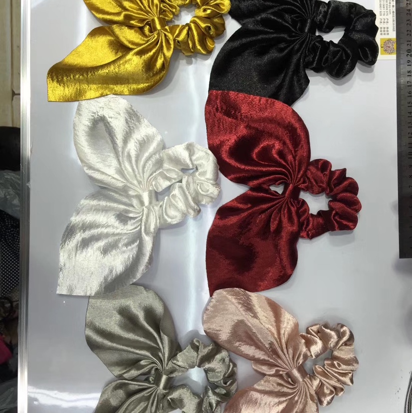 Solid-colored glossy swallow-tailed hair ties