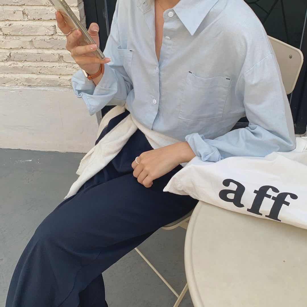 A simple, light-colored shirt with rolled sleeves