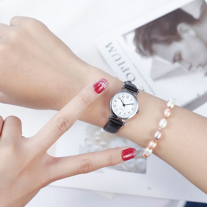 A digital watch with a thin leather strap detail image 10