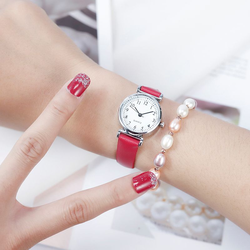 A digital watch with a thin leather strap detail image 9