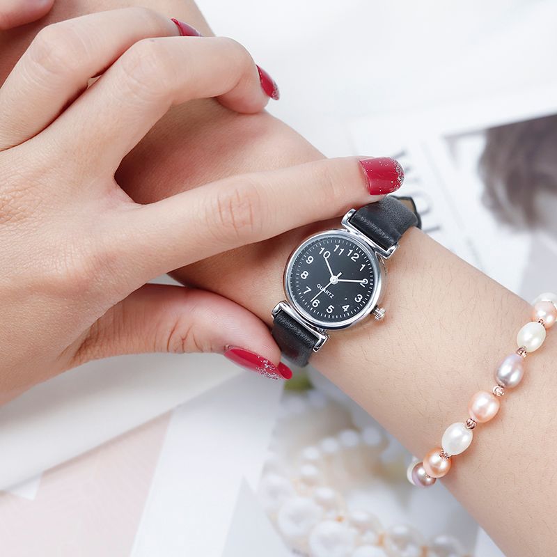 A digital watch with a thin leather strap detail image 8