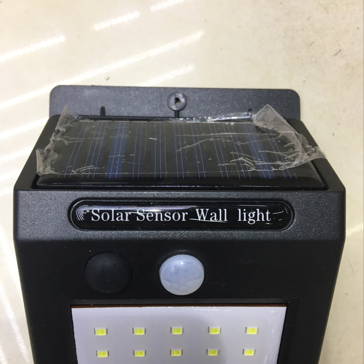 Solar wall light detecting motion in backyard at night