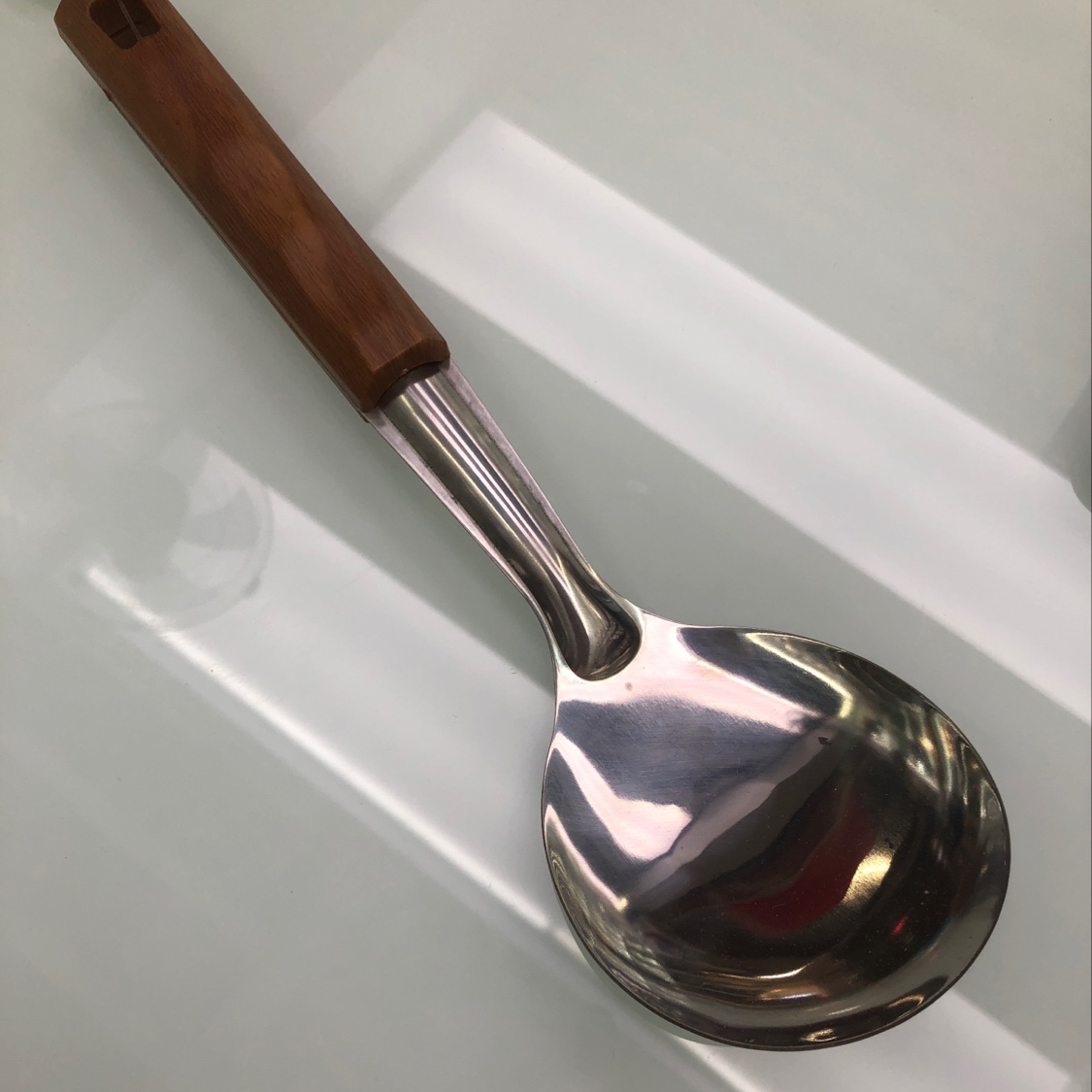 A short rice spoon with a wooden handle imitation