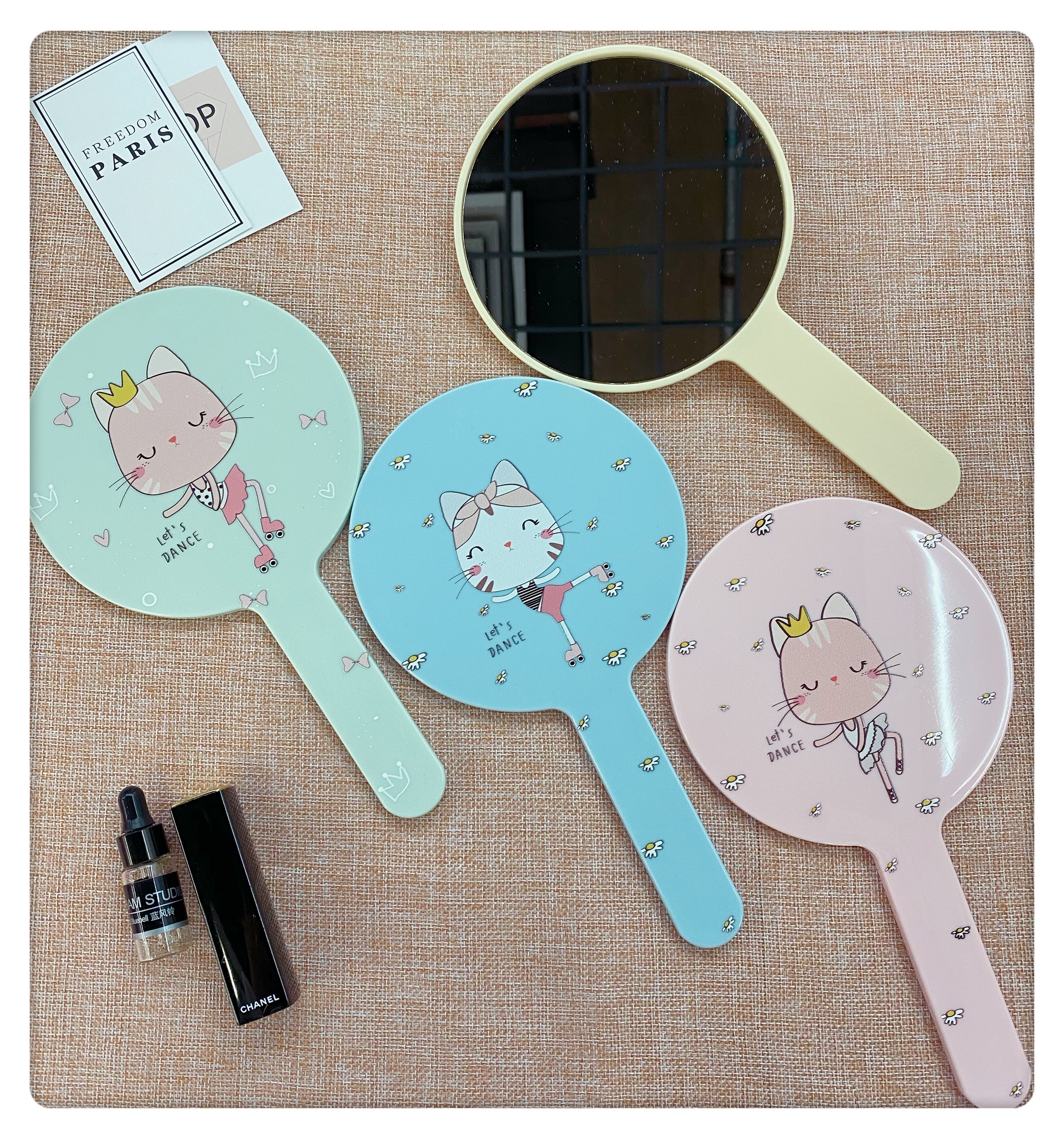 Colorful circular hand-held mirror with painted handle mirror undefined