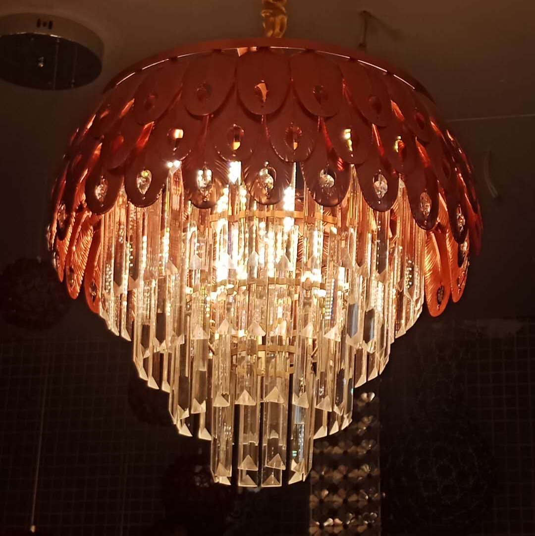 The bedroom is decorated with a crystal chandelier