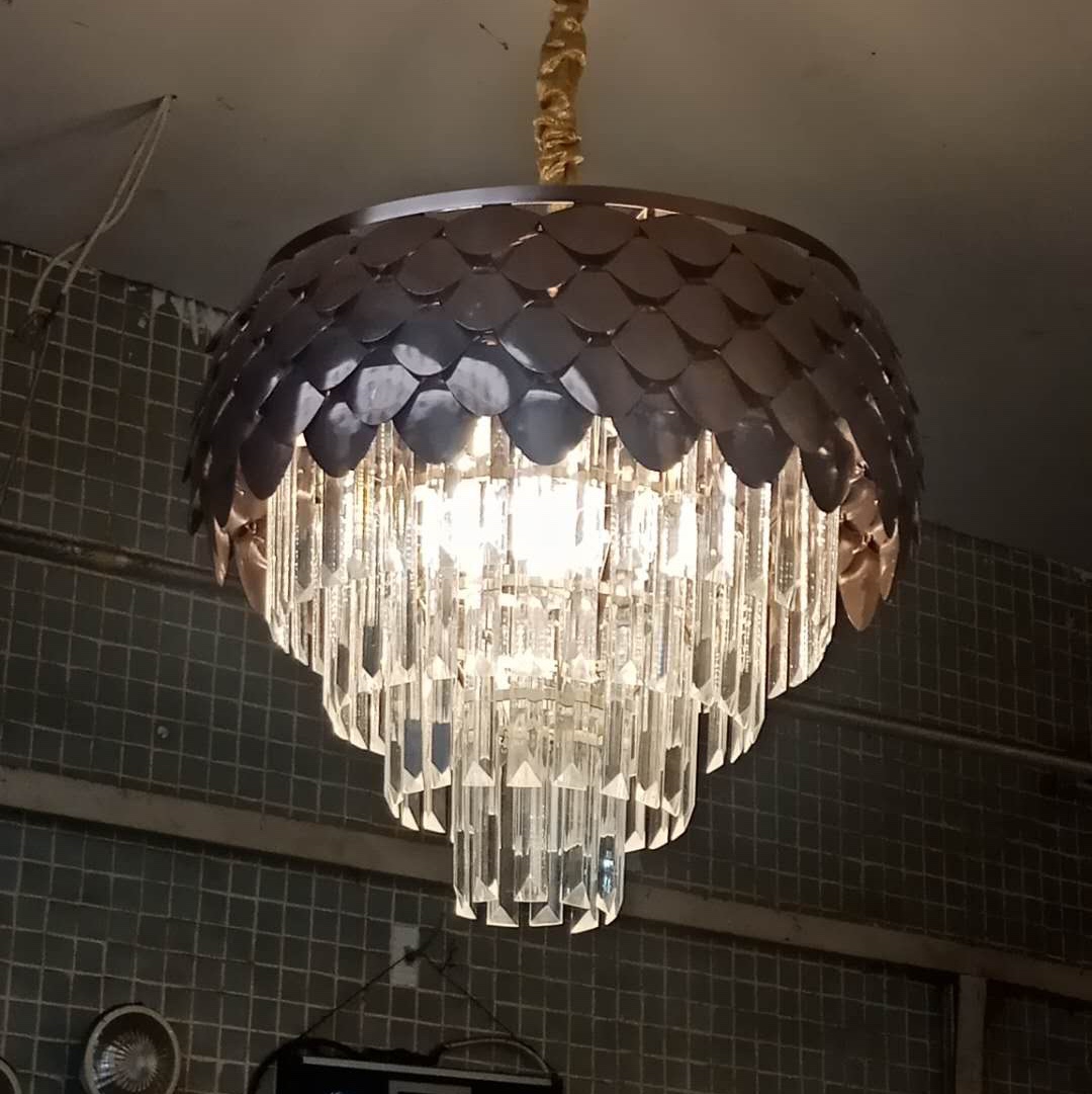 The bedroom is decorated with a crystal chandelier details Picture