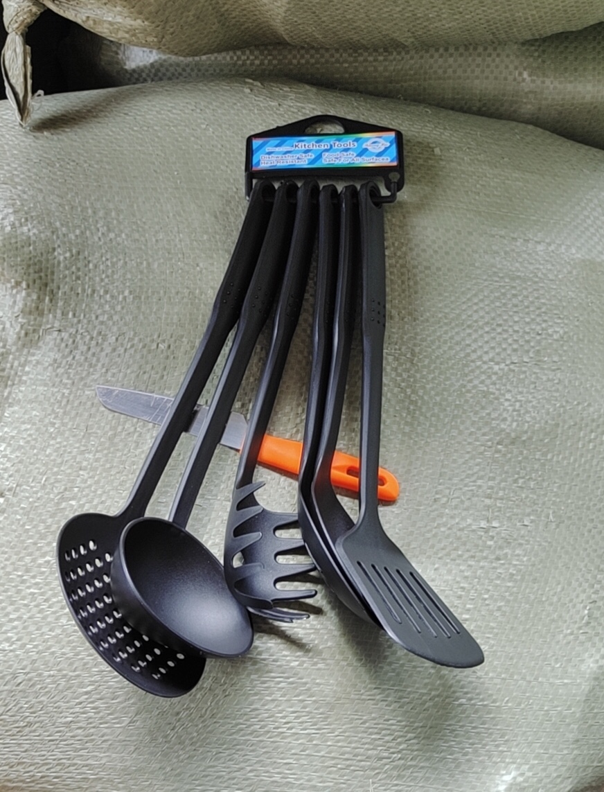 A set of 6 black plastic spatulas
