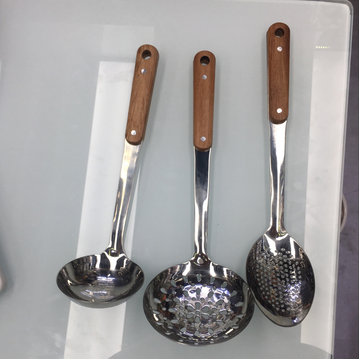 A two-nail soup spoon with a wood-grain handle