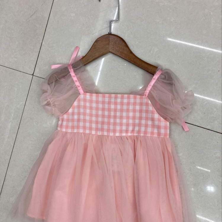 The plaid pattern of the little dress