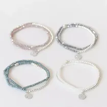 Three jewels of crystal and two rings next to 168