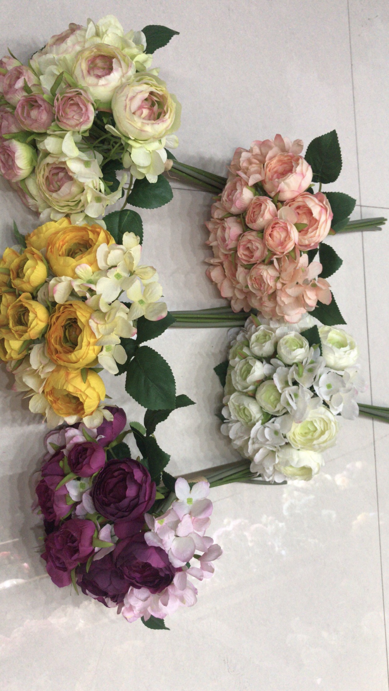 A hand-held bouquet of lotus and hydrangea details Picture