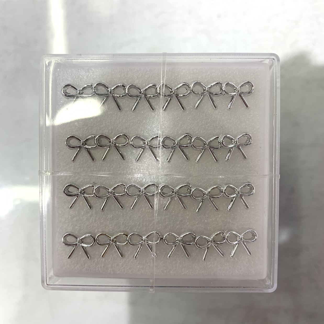 Silver bow tie hollow stud earrings thumbnail