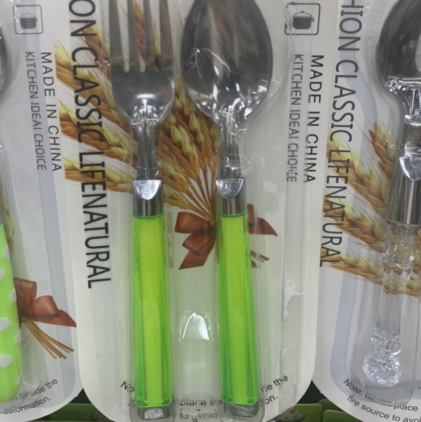 The two-piece knife and fork set has green handles and is transparent