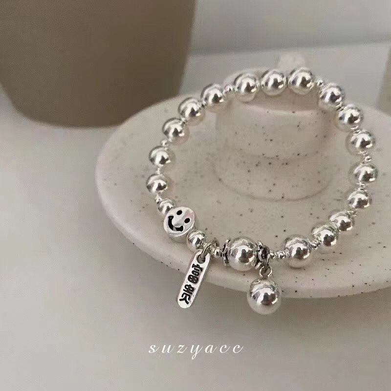 A pure silver bracelet with a smiling face