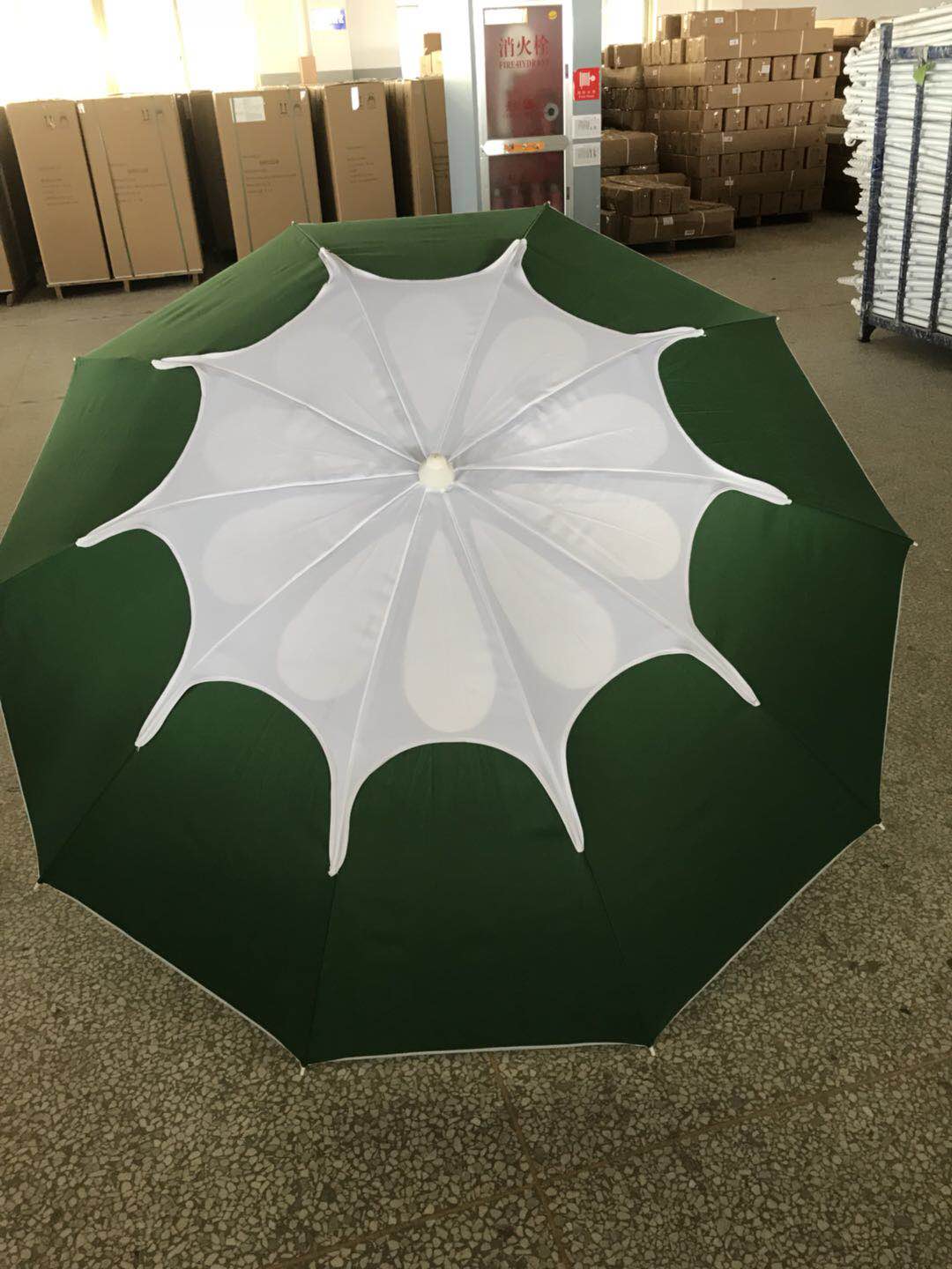 A portable folding umbrella with a blue canopy for wind and sun protection pic 2