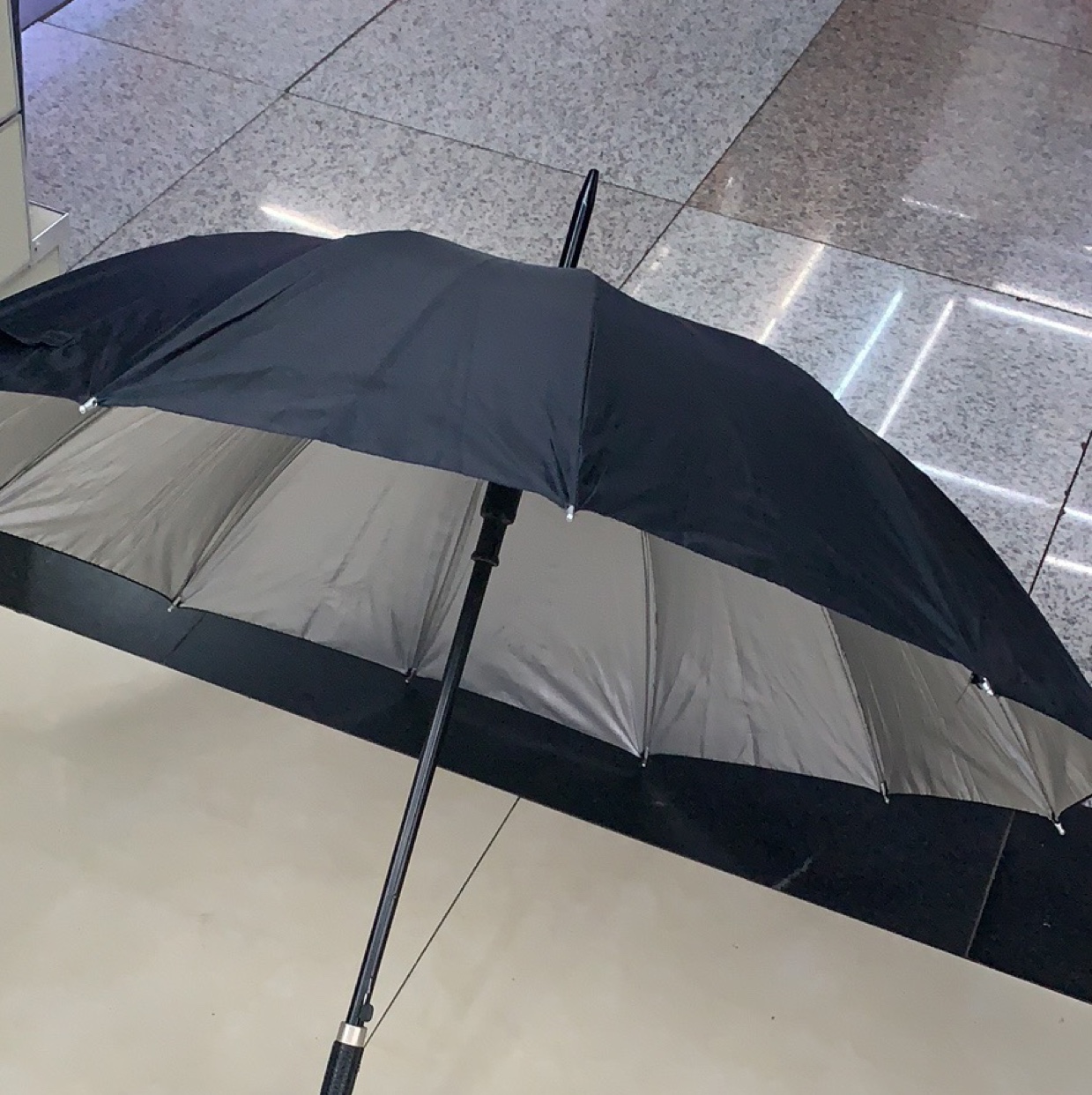Black and silver plastic umbrella