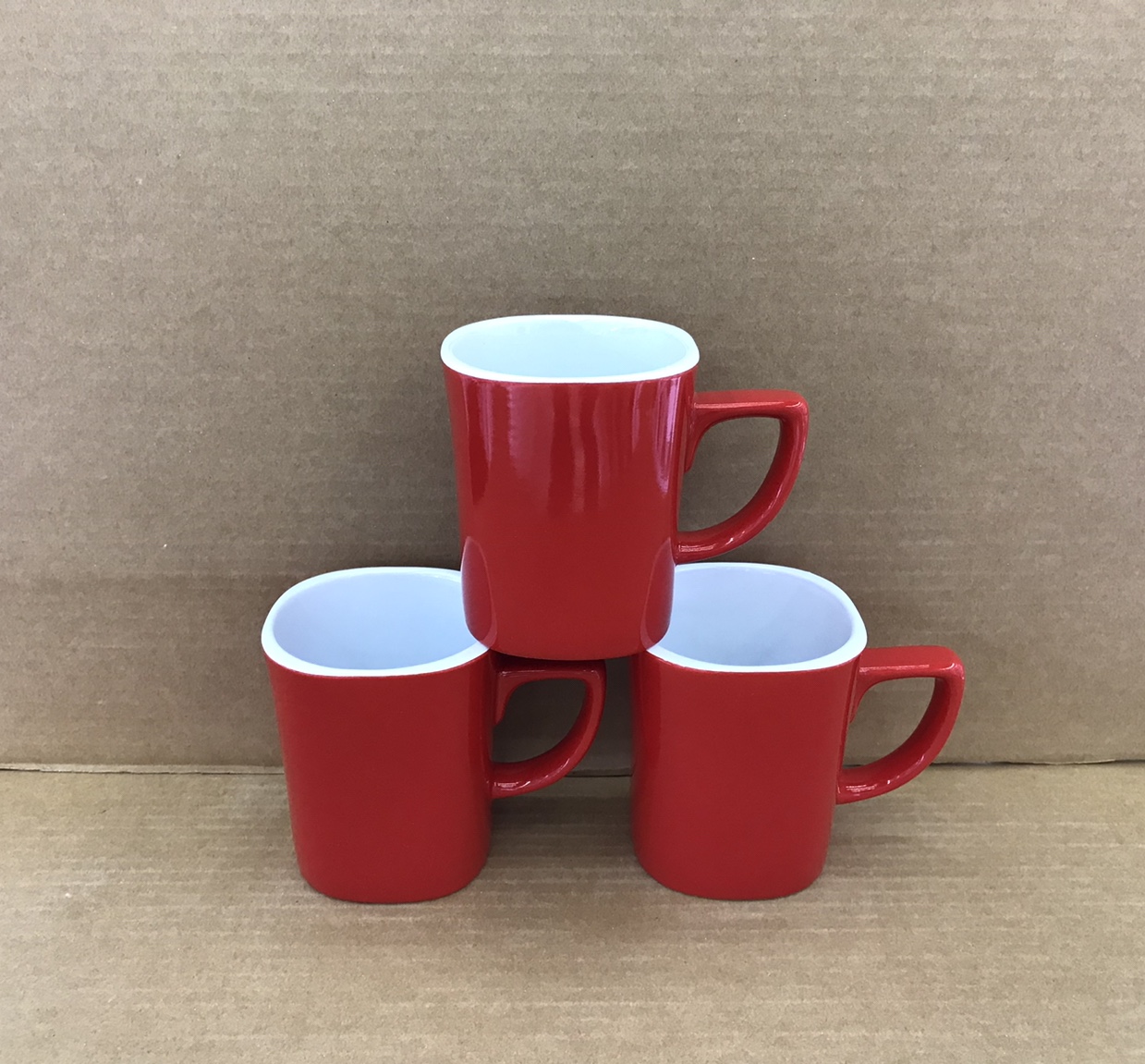 A 14oz square cup with white inside and red outside