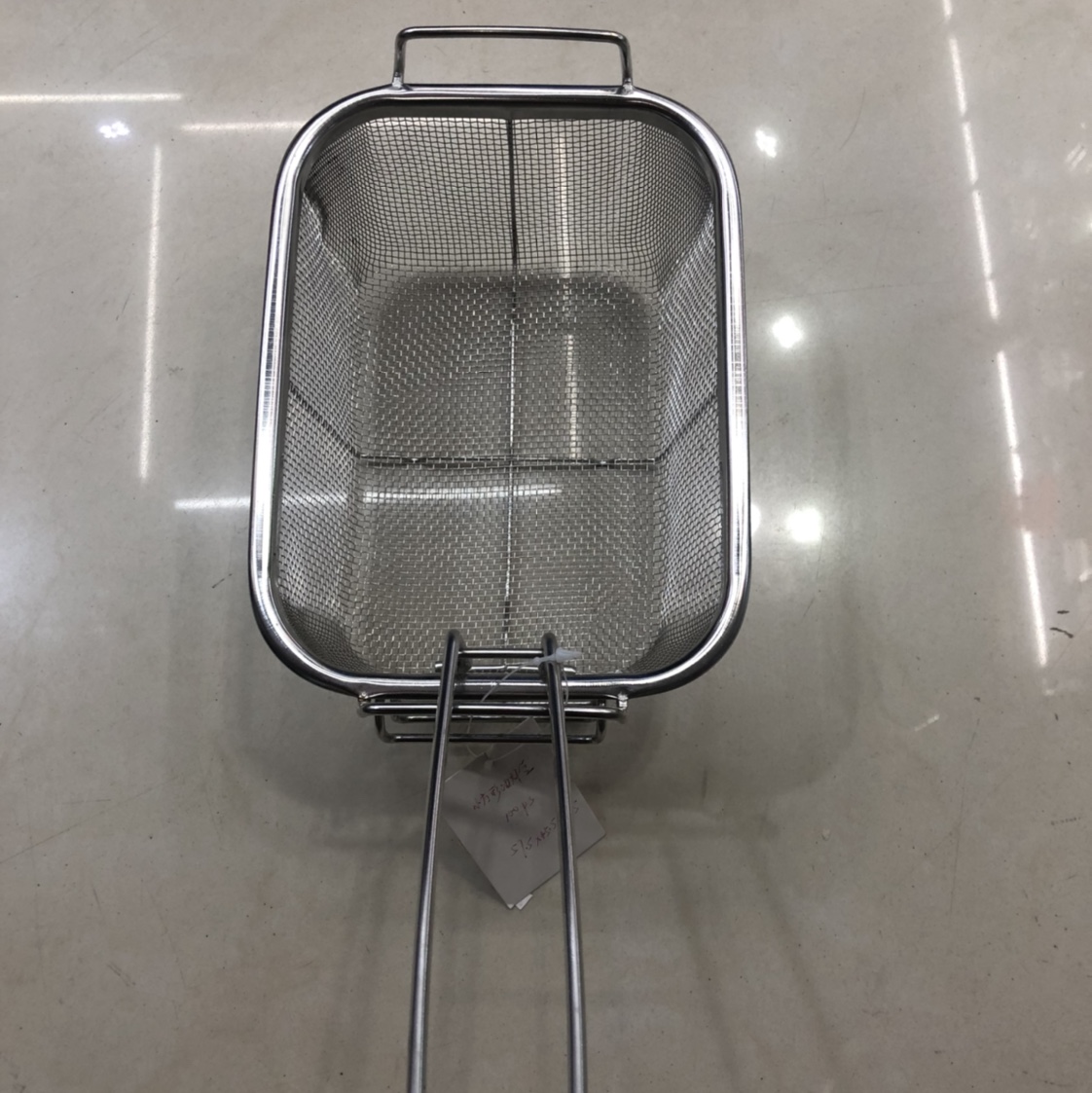 A small square frying basket