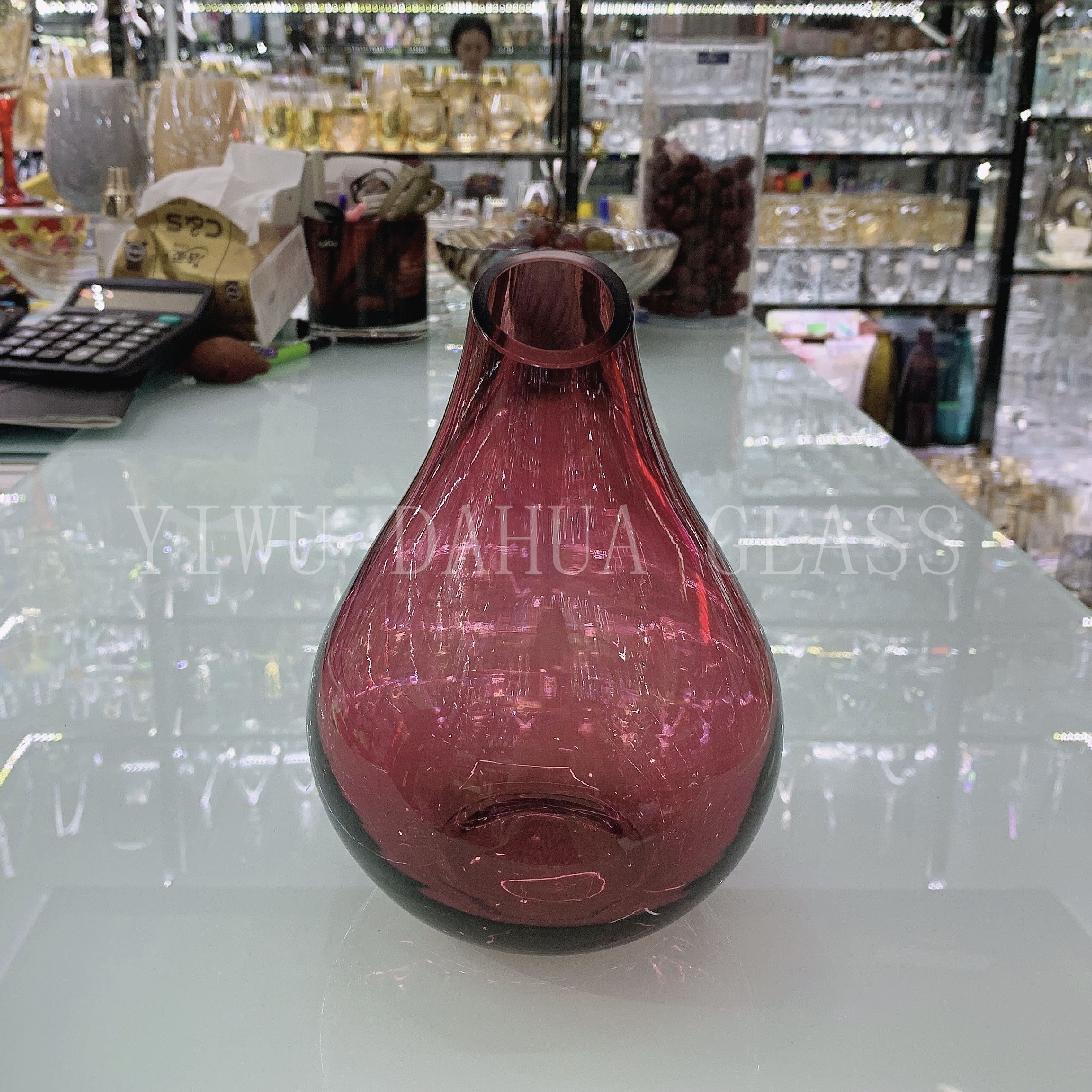 Vase placed next to a book and candles