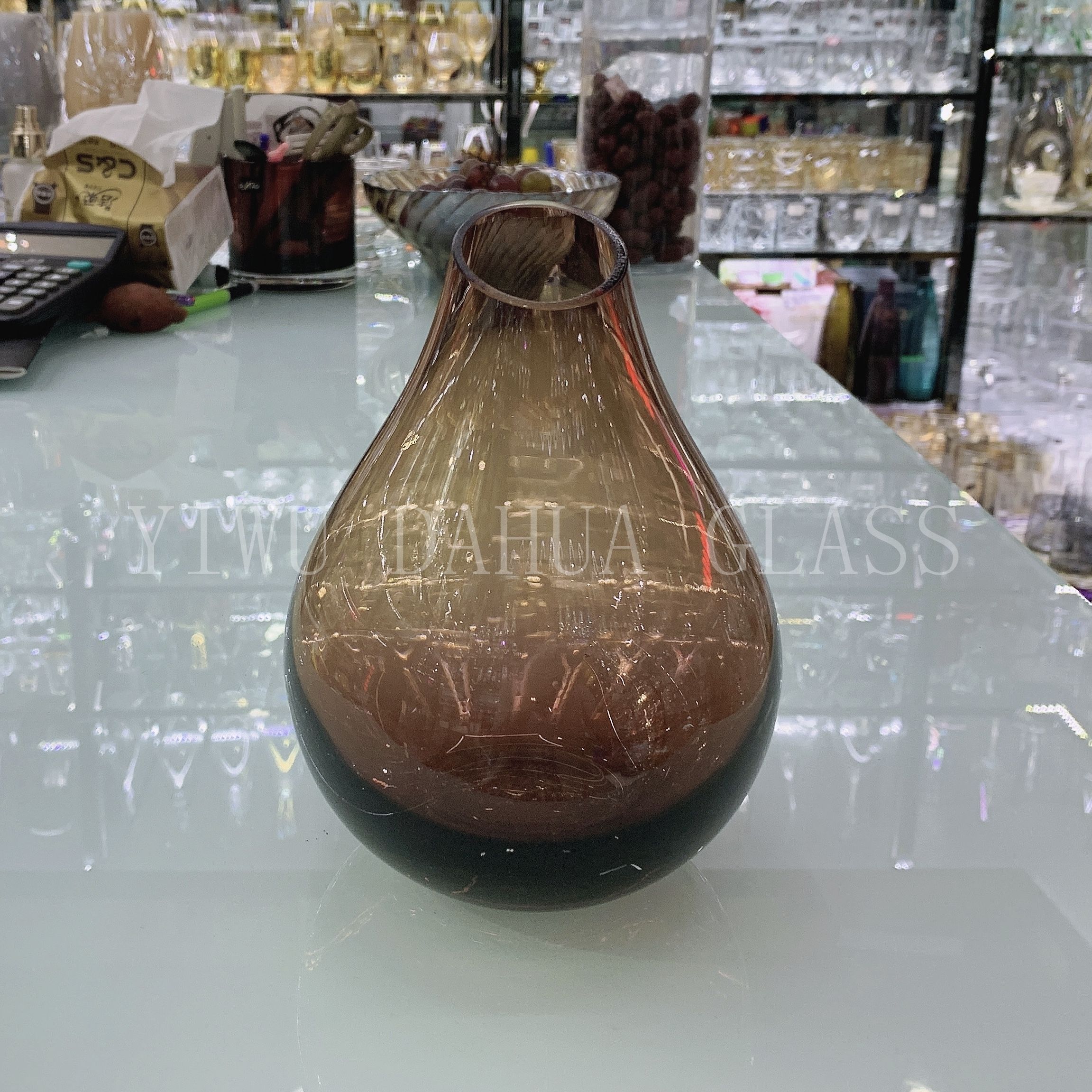 Vase in a thoughtfully styled room with books and plants