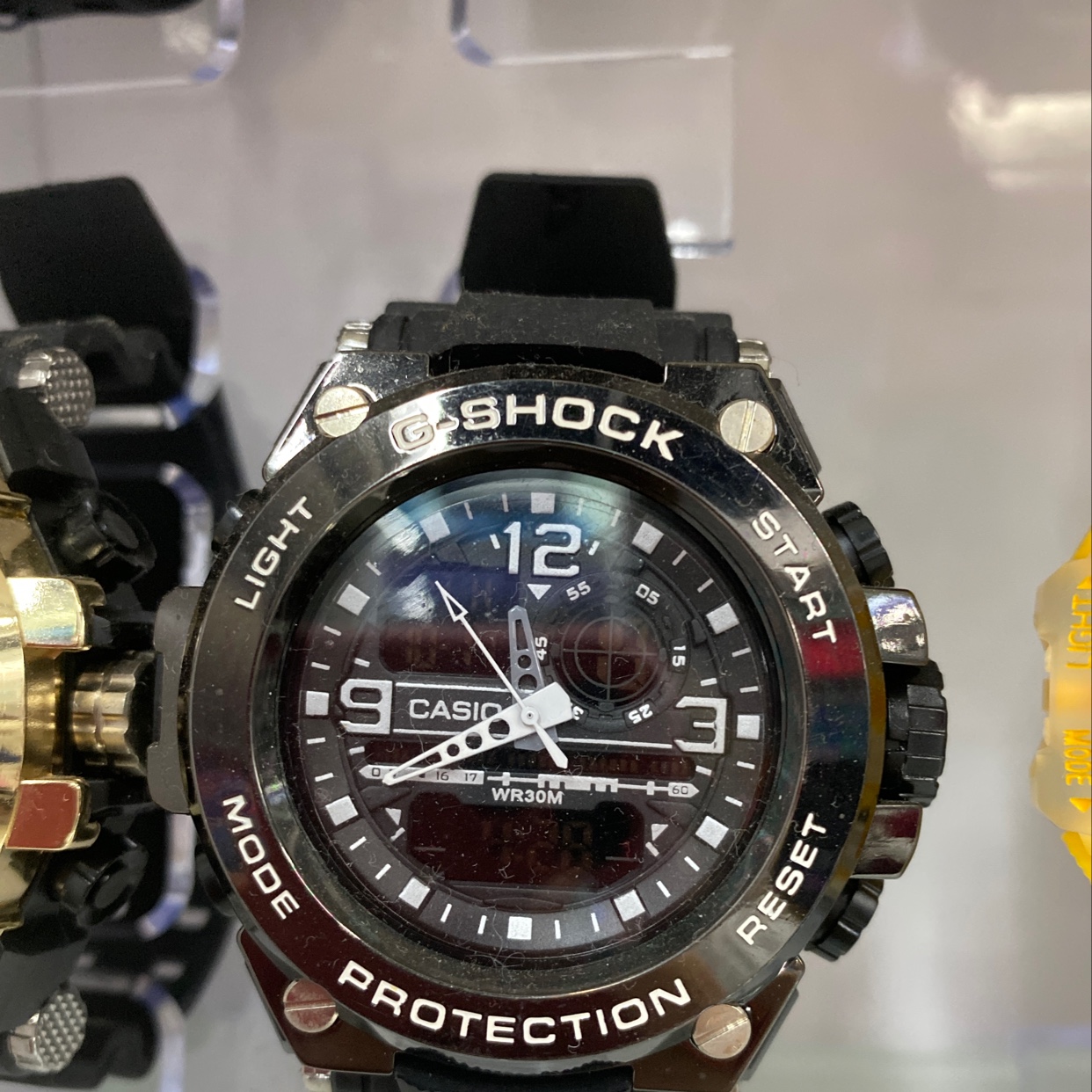 The watch features a black sporty style