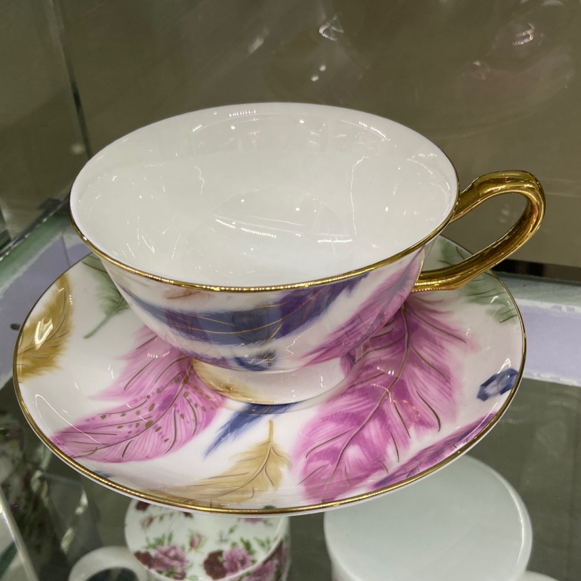 Close-up of Feather Gold Cup showing delicate gold feather detailing