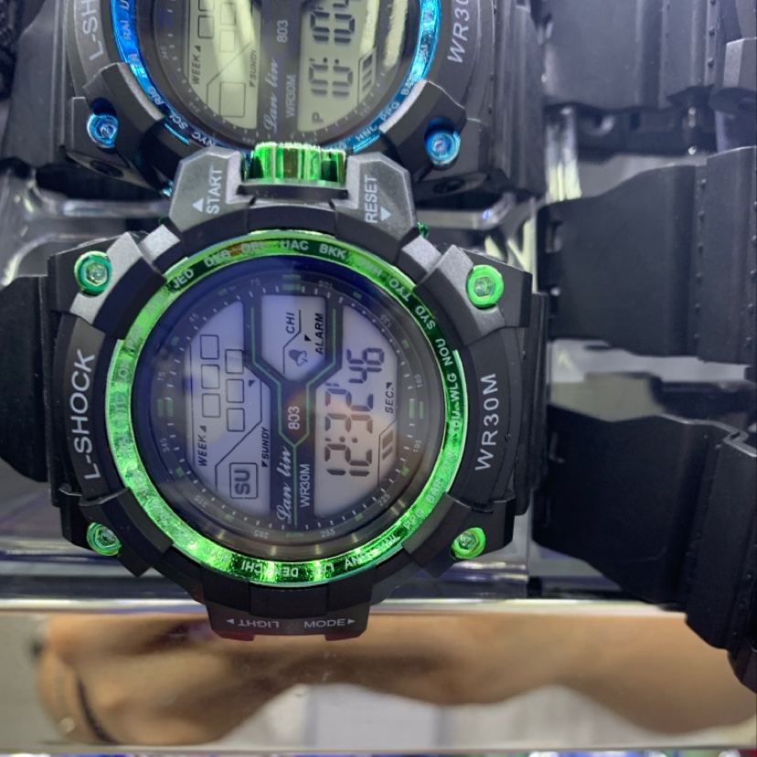 The watch has a black student green dial