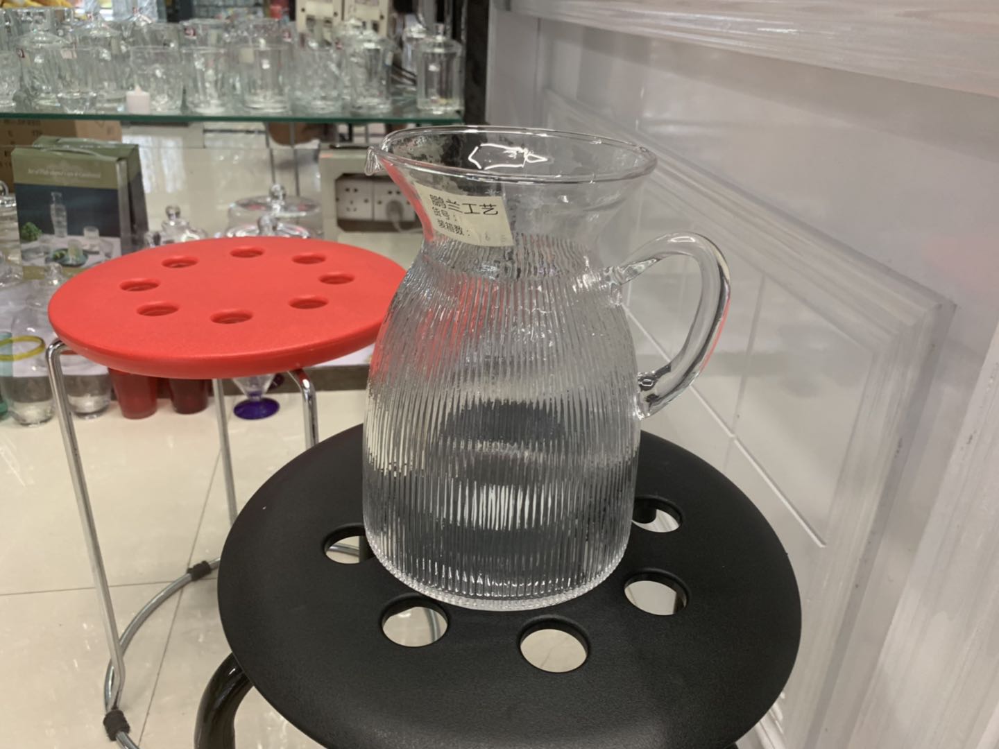 A large-bellied glass water bottle
